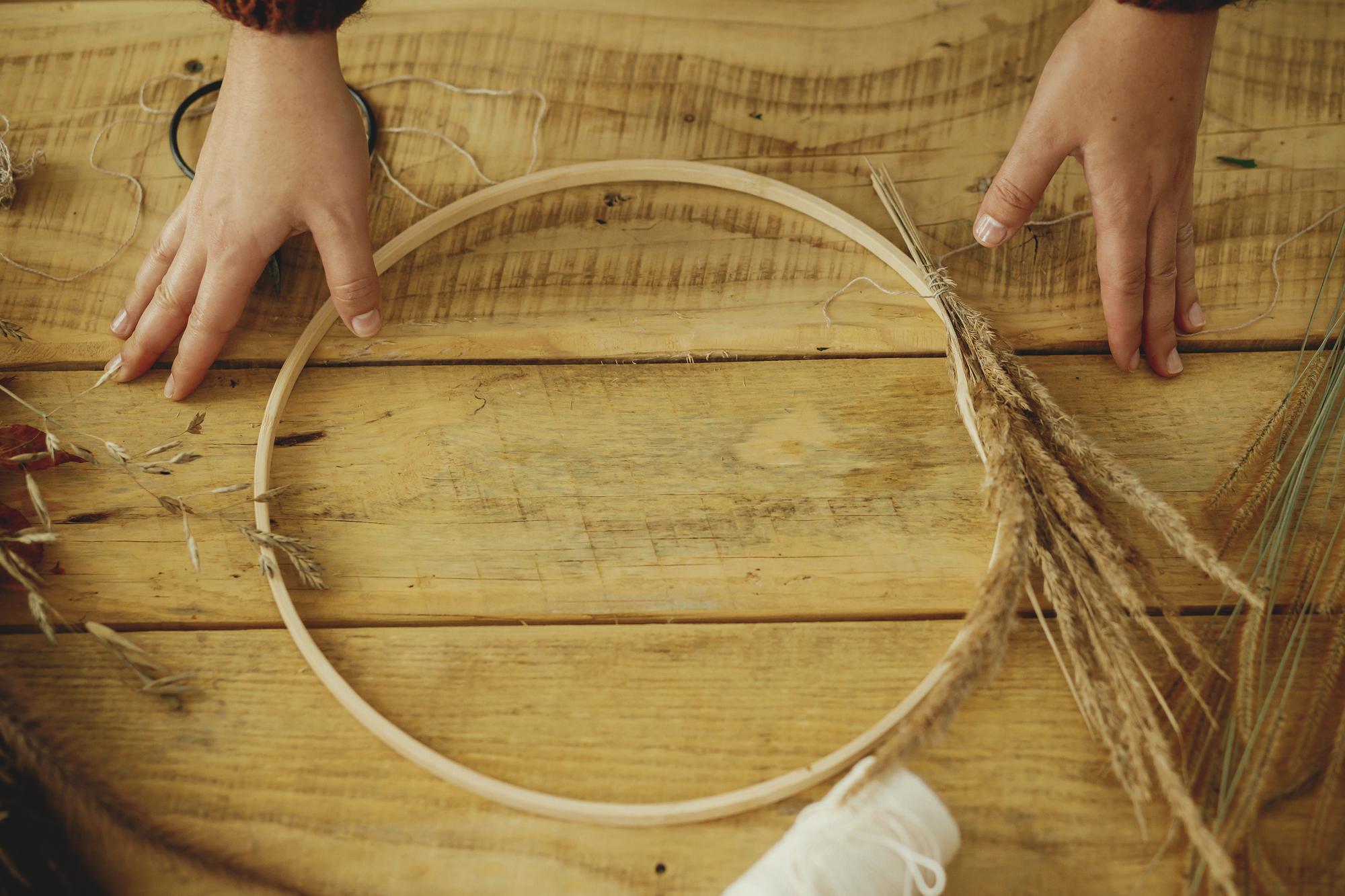close-up of hand embroidery hoop with earth-toned threads